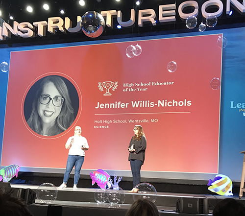 Jennifer accepting award at conference 